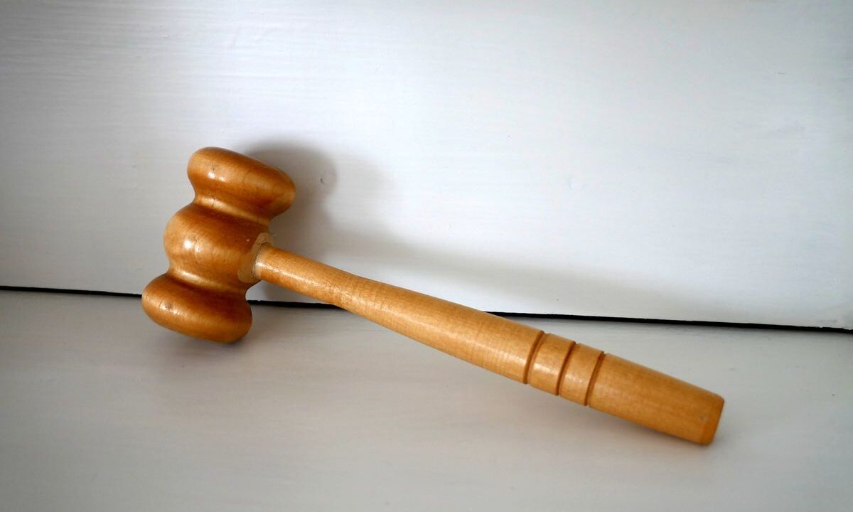 Wooden judges gavel on table representing court sanctions warning
