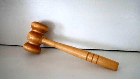 Wooden judges gavel on table representing court sanctions warning