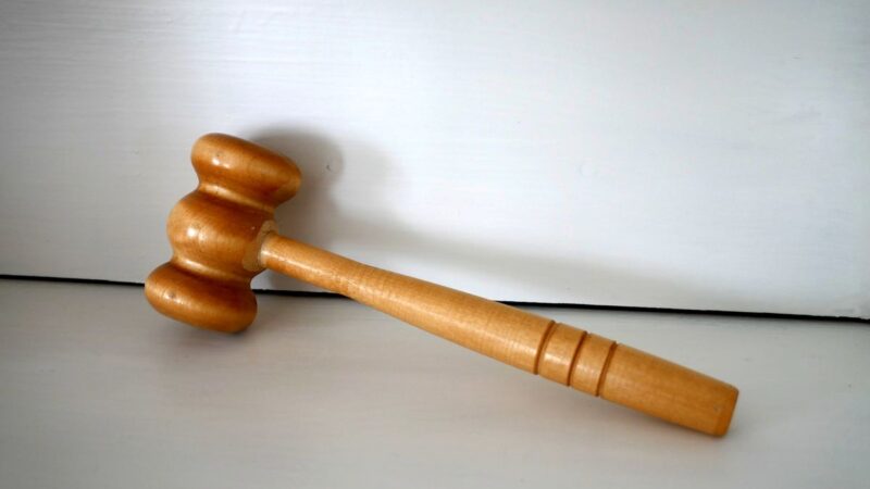 Wooden judges gavel on table representing court sanctions warning
