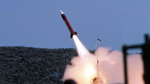 Patriot interceptor missile launching into a blue sky